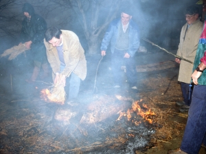 [Txerriaren azala erretzeko gariaren lastoari su ematen]