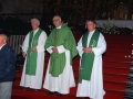 El sacerdote Juan Mujika y otros dos clérigos a sus lados en la iglesia parroquial de San Miguel