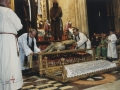 Los sacerdotes introduciendo en la urna de cristal el cuerpo de Cristo en la procesión de Semana Santa